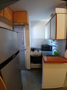 a kitchen with a refrigerator and a stove at Neyen in La Plata +12 photos