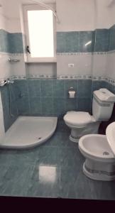 a bathroom with two toilets and a sink at Dhimarko Guest House in Përmet +13 photos