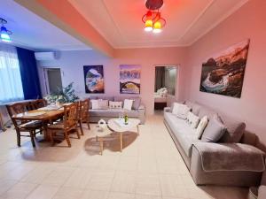 a living room with a couch and a table at Dhimarko Guest House in Përmet