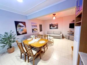 a dining room with a table and a couch at Dhimarko Guest House in Përmet