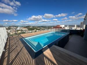 a swimming pool on the roof of a building at Studio Brooklyn - 3 minutos da EPCAR in Barbacena