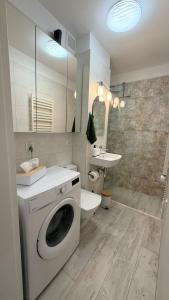 a bathroom with a washing machine and a sink at Studio 13 Warsaw in Warsaw +29 photos