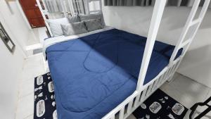 a bunk bed with blue sheets on a ladder at 338 Studio in Ban Liam