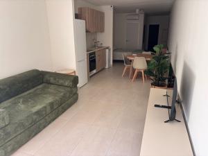 a living room with a couch and a kitchen at APARTAMENTO LEPANTO in Almazora +2 photos