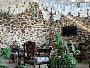 a dining room with tables and chairs and a tv at Casa Pahpaqui in Tequisquiapan