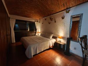 a bedroom with a bed in a room at Casa Pahpaqui in Tequisquiapan +30 photos