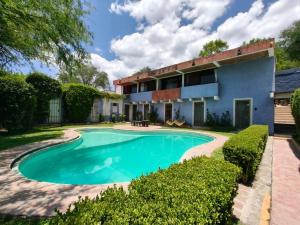 a swimming pool in front of a house at Casa Pahpaqui in Tequisquiapan