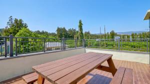 a wooden table on the balcony of a house at Jeju DK House Pension in Seogwipo