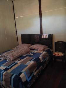 a bed with a quilt and pillows on it at STELAMARIS HomeStay in Pulau Bunaken +1 photo