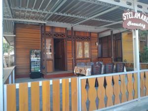 a porch of a house with a sign on it at STELAMARIS HomeStay in Pulau Bunaken