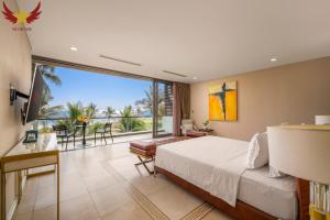 a bedroom with a bed and a large window at The Five Stars Villa 6 Bedrooms Beachfront in Danang