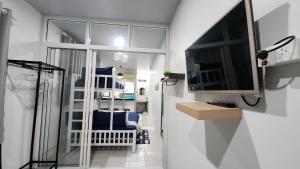 a living room with a tv and a living room with at 338 Studio in Ban Liam