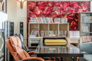 a room with a book shelf filled with dvds at Muuido Haedungsil Pension in Incheon