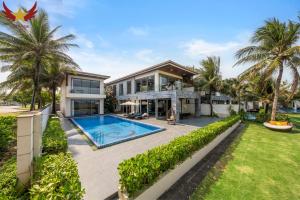 an exterior view of a house with a swimming pool at The Five Stars Villa 7 Bedrooms Beachfront in Danang