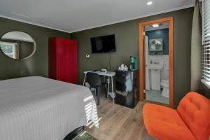a bedroom with a bed and a desk and a mirror at Berkshire Lake Lodge in Becket