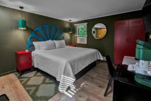 a bedroom with a bed with a blue headboard at Berkshire Lake Lodge in Becket