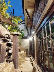 a room with a stone wall and a window at Five Star Guest house in Chiang Mai