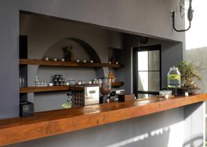a kitchen with a wooden counter top in a room at Iron Wave Uluwatu in Bingin Beach +45 photos