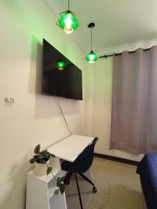 a room with a desk and a tv on the wall at Casa Florencia Hab 1 Florencia in Guayaquil