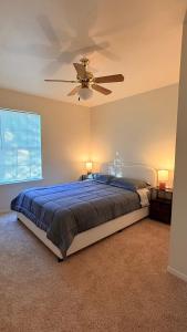 a bedroom with a bed with a ceiling fan at My apartment in Georgetown 2 Bedroom in Georgetown