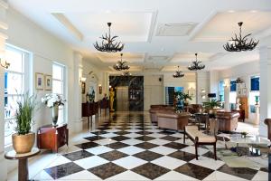 a lobby of a hotel with a checkered floor at Le Cannes, a Recall Luxe Hotel in Chiang Mai