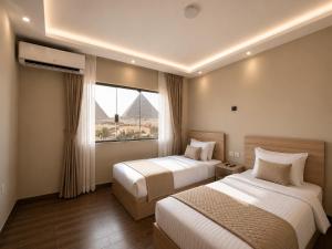 a hotel room with two beds and a window at Royal Aida Pyramids View INN in Cairo