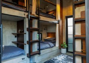 a room with two bunk beds and a window at Iron Wave Uluwatu in Bingin Beach