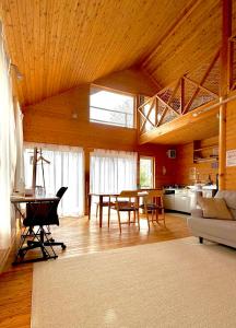 a living room with a table and a kitchen at Tokachi Mikage forest villa in Mikage +19 photos