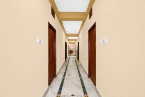 a corridor of a building with two doors and a hallway at Hotel O Aarshi Palace in Cuttack +26 photos