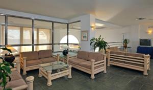 a living room with couches and a table at SOL by Meliá Los Fenicios in La Herradura