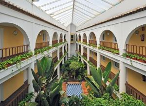 an indoor courtyard with a pool in a building at SOL by Meliá Los Fenicios in La Herradura +18 photos