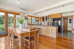 a kitchen with a wooden table with chairs and a counter at Sheena Apartment in Manila +5 photos