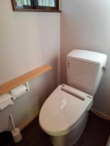a bathroom with a white toilet in a room at 茶室山谷庵 in Gero