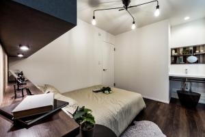 a bedroom with a bed and a desk with a laptop at ResoLife in Kochi