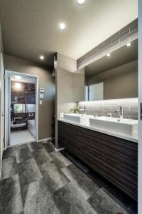 a bathroom with a large sink and a large mirror at ResoLife in Kochi