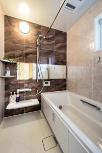 a bathroom with a tub and a sink at ResoLife in Kochi