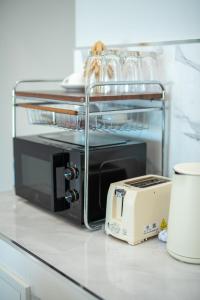 a toaster sitting on top of a kitchen counter at Turtle Tales-Tao Kra in Thai Muang
