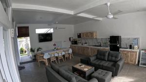 a living room with a couch and a table and a kitchen at Villa Segara Agung Amed in Amed