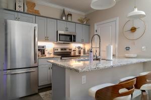 a kitchen with a stainless steel refrigerator and cabinets at Chic Townhome near LA Tech in Ruston