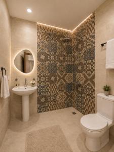 a bathroom with a toilet and a sink and a mirror at Royal Aida Pyramids View INN in Cairo