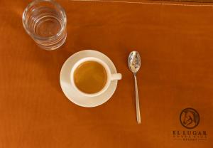 a cup of coffee on a table with a spoon at El Lugar Hotel & Nature Reserve Costa Rica in Tigre +49 photos