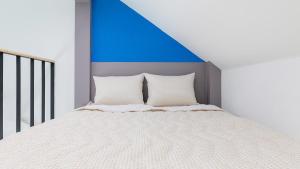 a bedroom with a bed with a blue ceiling at Gapyeong Haneulsup Spa Pension in Gapyeong