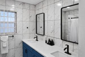 a bathroom with two sinks and a mirror at Villa del Nique in Pembroke +77 photos