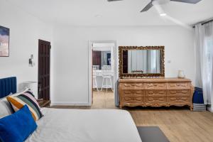 a bedroom with a dresser and a mirror at Villa del Nique in Pembroke