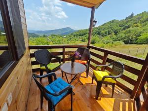 a porch with chairs and a table with a view at Qusarion - ქუსარიონი in Agara