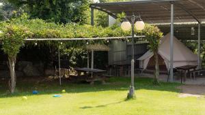 a tent and a picnic table in a yard at Yangyang Slowstay Pension in Yangyang +2 photos