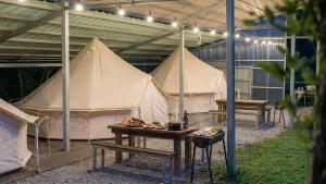 a group of tents in a building with a table at Yangyang Slowstay Pension in Yangyang