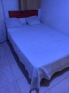 a bed with a blue light on top of it at Hospedaje Lima Suite in Piura +2 photos
