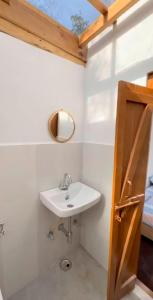 a bathroom with a sink and a mirror at Nivriti Stays in Nainital