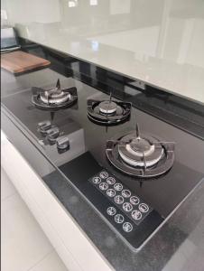 a stove top with four burners on top of it at Nana's Bar & Hotel in Nong Prue